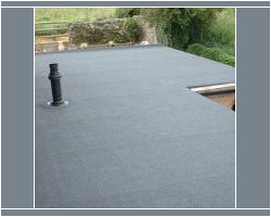 Elevated view of a newly installed grey flat roof waterproofing membrane featuring a plumbing vent pipe and a roof skylight opening.