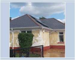 Front view of a detached bungalow featuring a dark slate roof with solar panels, white PVC guttering, and weathered yellow rendered walls requiring repair.